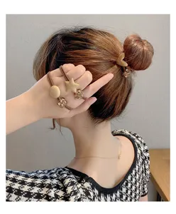 Detailed view of stylish korean hair ties and bun maker featuring star and crystal bead accents.