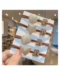 Close-up detail of stylish Korean style hair ties set featuring resin charms and rhinestone beads on card.