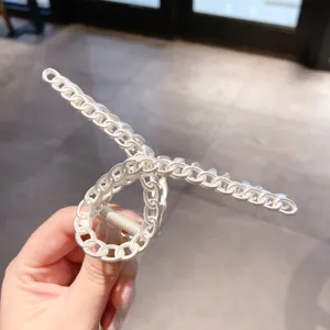 Silver metal chain link hair claw clip, elegant geometric hollow hair accessory for women styling.
