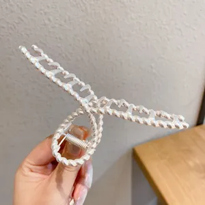Detail view of the silver metal hair claw clip featuring twisted bead design for stylish daily wear.