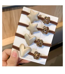 Close-up detail of Korean style hair ties set featuring cute star and heart charms with rhinestones.