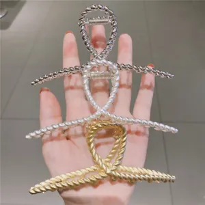 Metal hair claw clip for women, stylish twisted design hair accessory for thick hair.