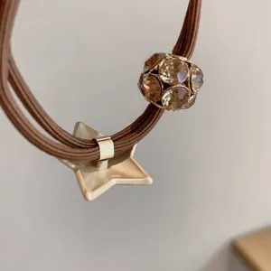 Minimalist brown hair tie with crystal faceted ball and chic star pendant charm for women.