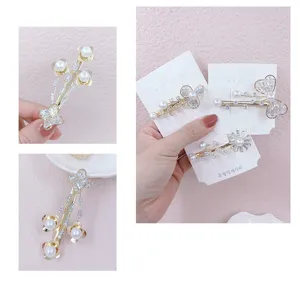 Pearl rhinestone hair clip detail view showcasing exquisite metal floral design and shiny crystal.