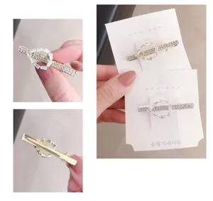 Detailed view of the elegant rhinestone geometric hair clip with sparkling crystals on display card.