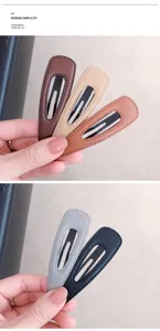 Close-up detail view of leather wrapped snap hair clips showcasing various chic colors.