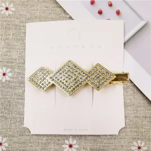 Gold-tone triple rhombus rhinestone hair clip detailed view, sparkling crystal duckbill barrette.