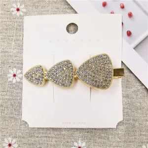 Gold metal rhinestone hair clip detail, elegant geometric triangle duckbill barrette fashion.