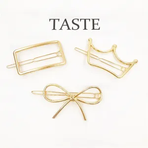 Detailed close-up of gold metal hair clips showcasing the geometric, crown, and bow designs.