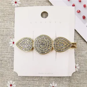 Detailed view of sparkling rhinestone metal hair clip, elegant crystal women barrette.