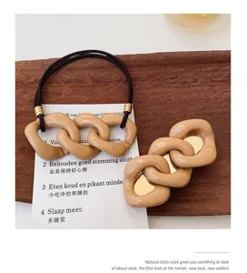 Sweet milk tea color hair rope and hair clip set with stylish chain link design for women.
