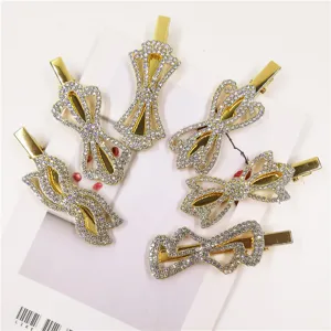 Golden rhinestone bow hair clips set, elegant metal duckbill hairpins for women and girls.