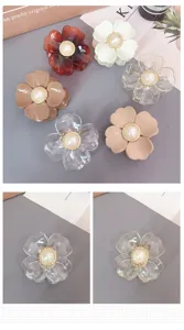 Detailed view of cute acrylic flower hair claw with pearl center, vibrant multiple colors.