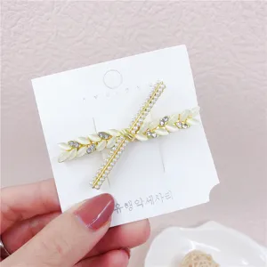 Pearl and cat's eye stone hair clip detail showing exquisite floral design and gold frame.
