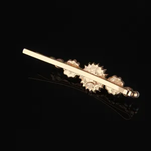 Gold metal hairpin with floral elements and pearls, sweet minimalist style hair accessory.