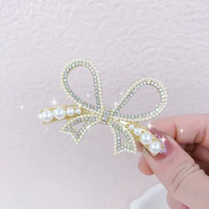 Exquisite pearl bow hair clip detail shot, elegant gold hairpin for women and girls daily wear.