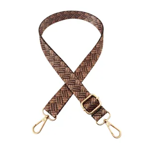 Detailopname van een 2,5 cm bruine vervangende tasband met gouden metalen gespen.