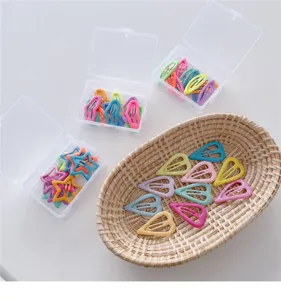 Colorful cute hair clips detail view, star and heart shapes in pastel macaron colors with boxes.