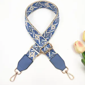 Etnisch bestickter Ersatz-Taschenriemen mit blauen Lederenden und goldenen verstellbaren Beschlägen.