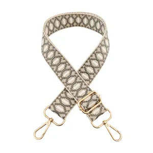 Adjustable replacement bag strap with jacquard geometric pattern and gold hardware.