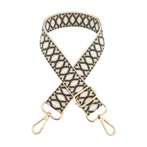 Woven adjustable replacement bag strap with gold-tone hardware and geometric patterned design.
