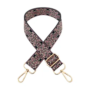 Detailed view of the wide embroidered replacement bag strap with adjustable gold hardware.