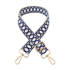 Close-up detail of blue and white geometric jacquard replacement bag strap with gold hardware.