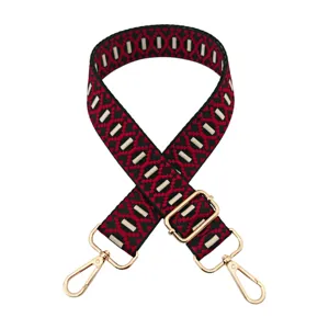 Adjustable replacement bag strap with red and black jacquard geometric pattern and gold hardware.