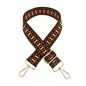 Adjustable replacement bag strap with jacquard embroidery pattern and gold tone metal hardware.
