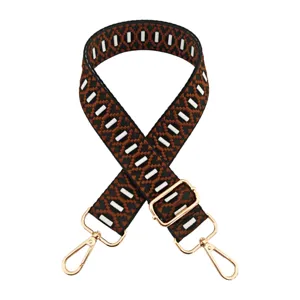Adjustable replacement bag strap with jacquard geometric webbing and gold-toned metal hardware.