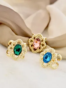 Detail shot of vintage gold hollow crystal scarf ring, elegant decorative apparel accessory.