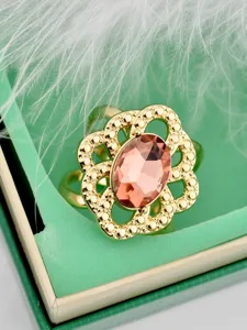 Vintage openwork floral scarf buckle detail showcasing elegant oval pink crystal design.