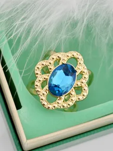 Retro gold-plated openwork floral scarf ring with blue oval crystal detail for women.