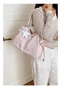 Pink polka dot shoulder tote bag with cute star pendant and embroidery details for women.