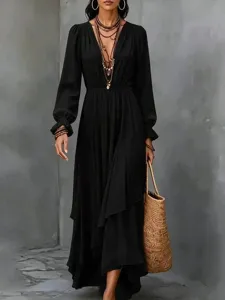Boho solid black long sleeve maxi dress detail view with ruffle hem and V-neck.