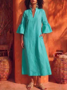 Stunning teal linen dress detail featuring elegant bell sleeves, deep V-neck, and side pockets.