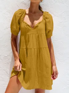 Primer plano del vestido informal con cuello en V y mangas abullonadas de tela texturizada.