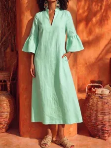 Mint green V-neck dress detail, elegant bell sleeves, stylish linen texture for daily wear.