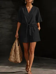 Black V-neck button down short sleeve shirt and shorts set detail view with woven bag.
