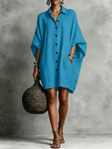 Close-up detail of the casual blue batwing sleeve shirt dress, soft texture and fine buttons.