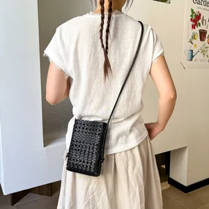 Detailed view of the stylish summer black woven mini crossbody phone bag, casual design.