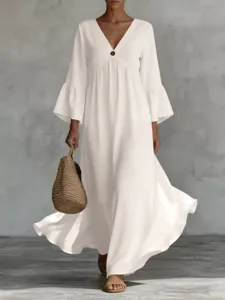 Elegant white V-neck long sleeve maxi dress with bohemian style, perfect for resort wear and vacations.