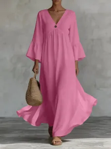 Detailed view of the flowy pink boho maxi dress featuring deep V-neck and stylish bell sleeves.