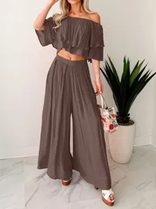 Detailed view of the stylish brown off-shoulder crop top and wide leg pants two-piece set.