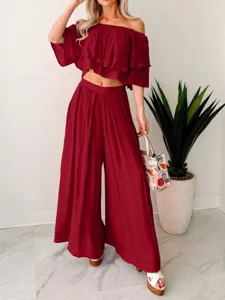 Chic burgundy off-shoulder ruffle crop top and wide-leg pants two-piece outfit detail.