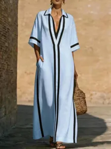 Dettaglio abito maxi azzurro chic con bordi neri a contrasto e vestibilità casual comoda.