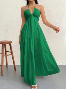 Stunning green halter neck maxi dress with deep V-neck and tiered A-line design for summer parties.
