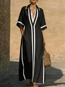 Dettaglio abito lungo nero a contrasto, scollo V revers stile vacanza casual donna.