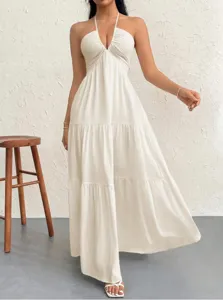 Detailed view of a chic halter neck deep V long dress with tiered ruffles and textured fabric.