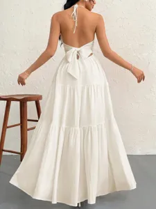 Details of a elegant white backless halter maxi dress, perfect for summer resort parties.